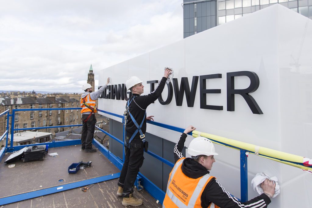 Specialized Signs team working at Exchange Tower