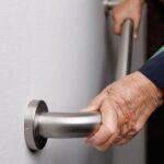Budget for adaptions to homes of elderly doubles to £20.9m Elderly woman holding grab rail