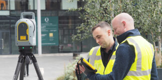 Construction workers carrying out geospatial measurement work