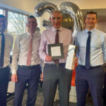 Clark finance director retires after more than 30 years with the business John Mooney presented with gift on his retirement