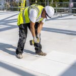 Roofing boards bring good energy to university centre Roofing boards being installed
