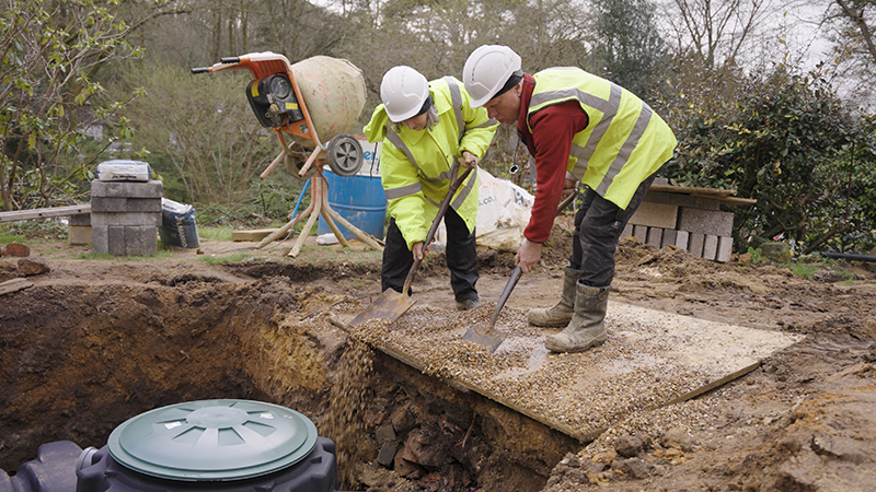 Workers at rainwater harvesting system