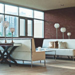Opening the door to a greener world room with 2 sofas & 6 lamps