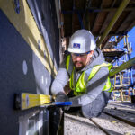 Procast Group allocated multiple lots on decarbonisation framework Construction worker carrying out retrofit work