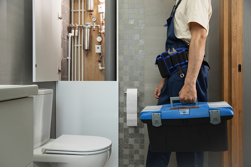 Plumber working in bathroom