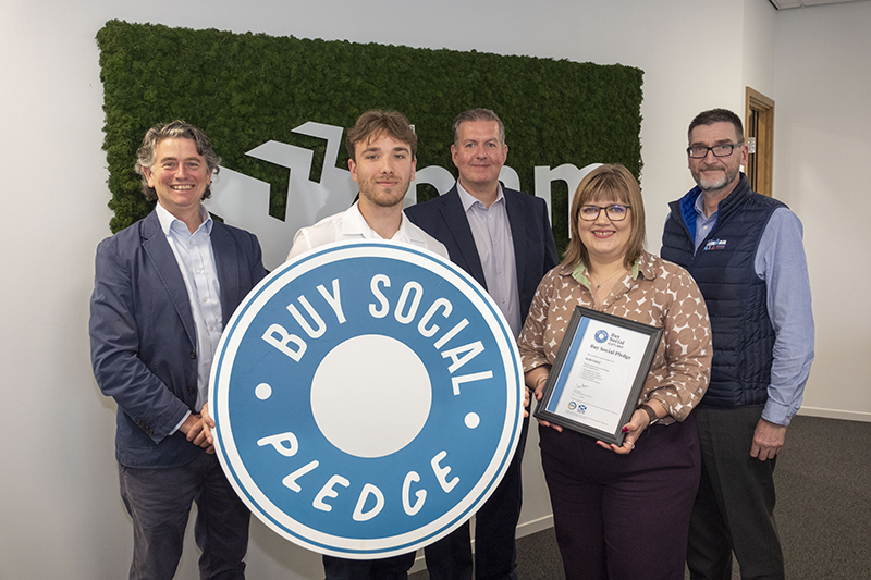 Representatives from BAM with Buy Social Pledge logo